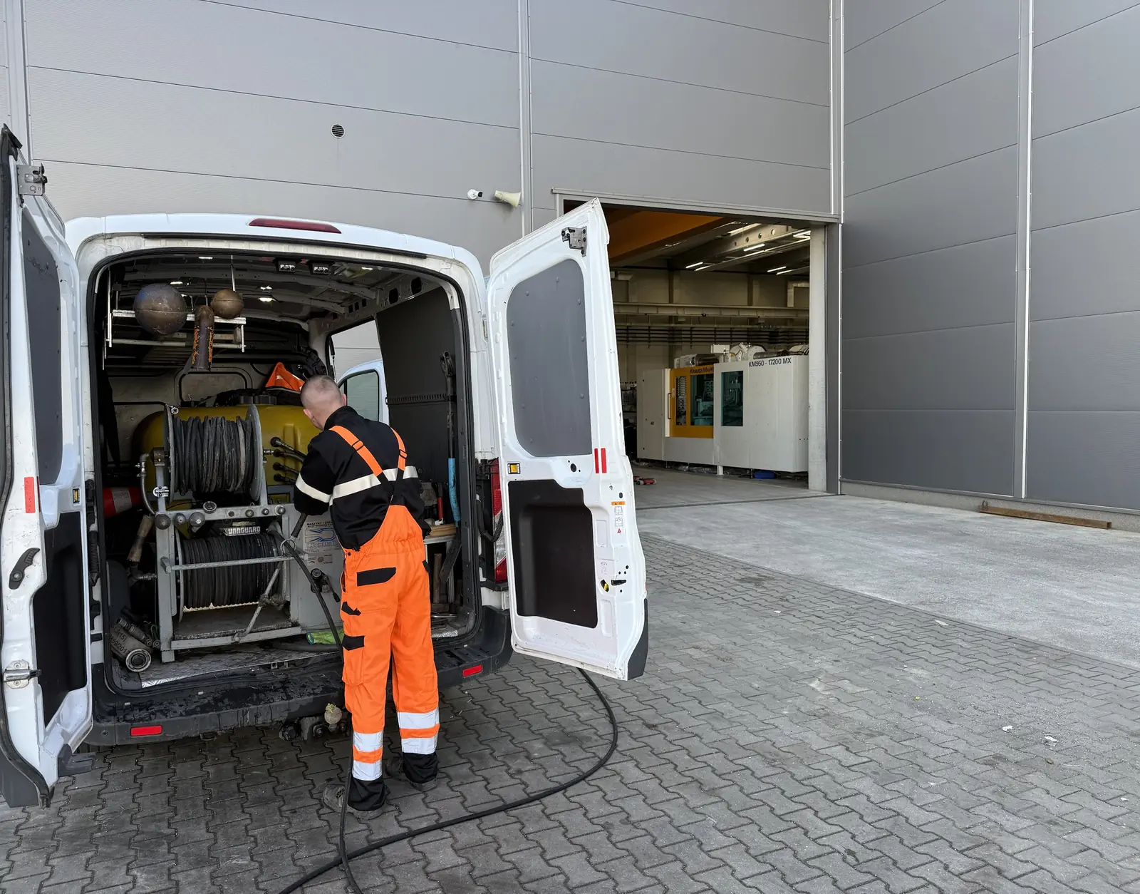 Technik SEKOR przy urządzeniu WUKO przed halą zakładu produkcyjnego